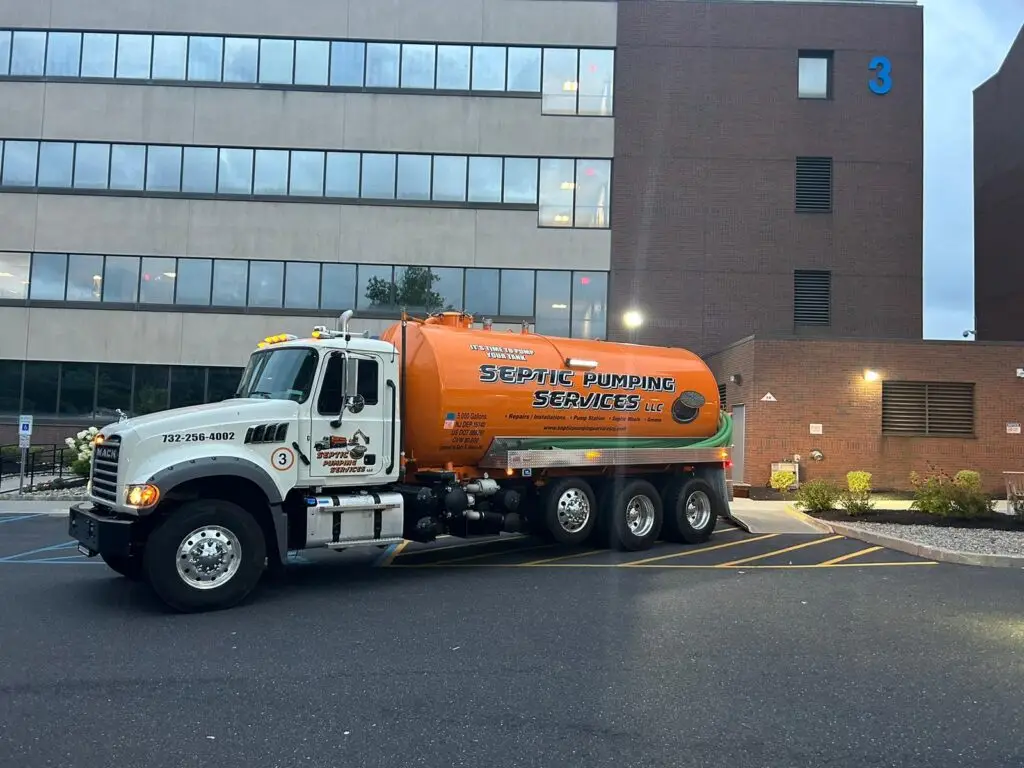 Septic Pumping Services NJ truck parked in front of a commercial building, ready for septic pumping service in New Jersey
